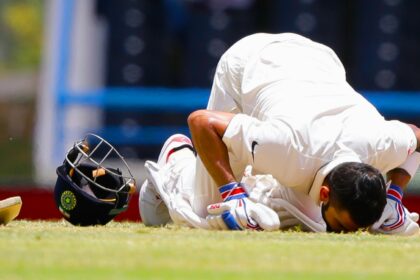 India's captain Virat Kohli kisses the field after scoring a double-century during day two of the first cricket Test match against West Indies at the Sir Vivian Richards Stadium in North Sound, Antigua, on July 22, 2016. (AP Photo)