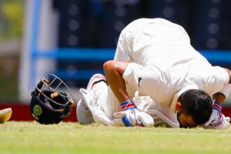 India's captain Virat Kohli kisses the field after scoring a double-century during day two of the first cricket Test match against West Indies at the Sir Vivian Richards Stadium in North Sound, Antigua, on July 22, 2016. (AP Photo)