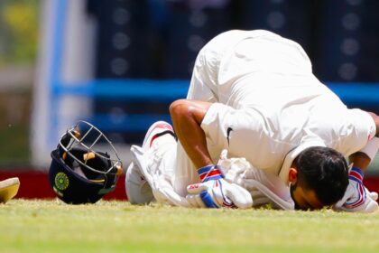 India's captain Virat Kohli kisses the field after scoring a double-century during day two of the first cricket Test match against West Indies at the Sir Vivian Richards Stadium in North Sound, Antigua, on July 22, 2016. (AP Photo)