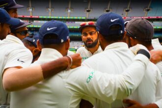 Former India captain Virat Kohli, center, addresses India teammates as they prepare to take to the field during the third Test in Melbourne. (AP Photo)