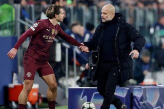 Manchester City's Jack Grealish with manager Pep Guardiola. (Reuters)
