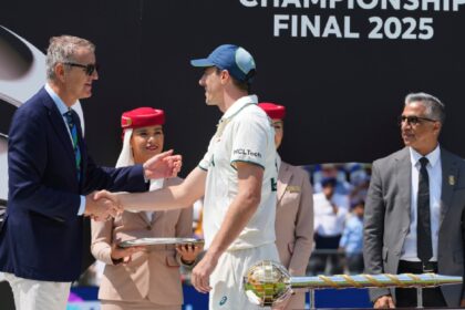 Australia's captain Pat Cummins is greeted by an official during the presentation ceremony after their loss in the World Test Championship final against South Africa at Lord's cricket ground in London, Saturday, June 14, 2025. (AP Photo)