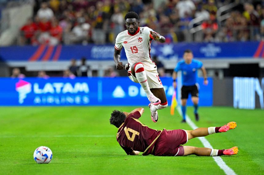 Canada's Alphonso Davies leaps over a Venezuelan player during last year's Copa América.