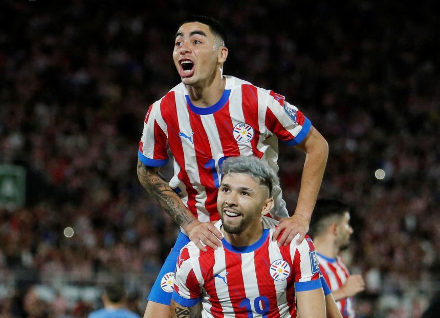 Paraguay's Miguel Almirón, top, and Julio Enciso celebrate a goal during a World Cup qualifier in June.