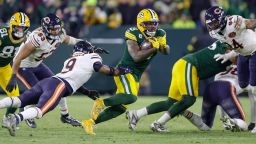 Green Bay Packers running back Josh Jacobs (8) rushes past Chicago Bears safety Jaquan Brisker (9) during an NFL football game between the Green Bay Packers and Chicago Bears Sunday, Dec. 7, 2025, in Green Bay, Wis. (AP Photo/Matt Ludtke)