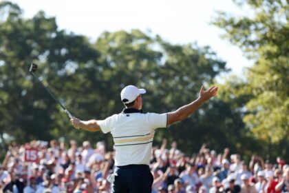 Rory McIlroy of Team Europe reacts to the crowd after making a birdie to halve the 15th hole during the Sunday singles matches of the 2025 Ryder Cup.