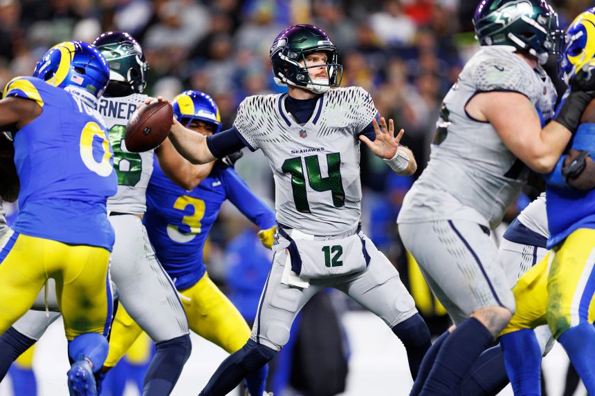 Sam Darnold drops back to pass during the third quarter against the Los Angeles Rams at Lumen Field.