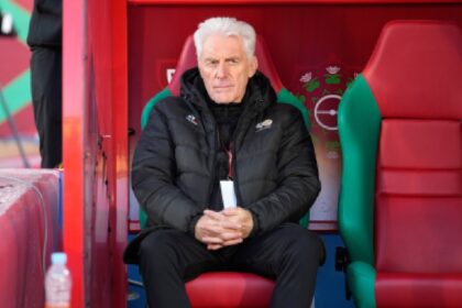 South Africa's head coach Hugo Broos sits on the bench ahead of the Africa Cup of Nations group B soccer match between Angola and South Africa in Marrakech, Morocco. (AP Photo)