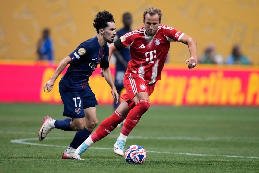 Paris Saint-Germain's Vitinha tries to get past Bayern Munich's Harry Kane during the Club World Cup quarterfinal soccer match between PSG and Bayern Munich in Atlanta, Saturday, July 5, 2025.