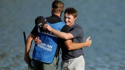 Blades Brown gets a hug from his caddie as Brown finishes at the ninth green for a 12-under-par 60 during the second round of the American Express golf event at the Jack Nicklaus Tournament Course at PGA West on Friday, in La Quinta, California.