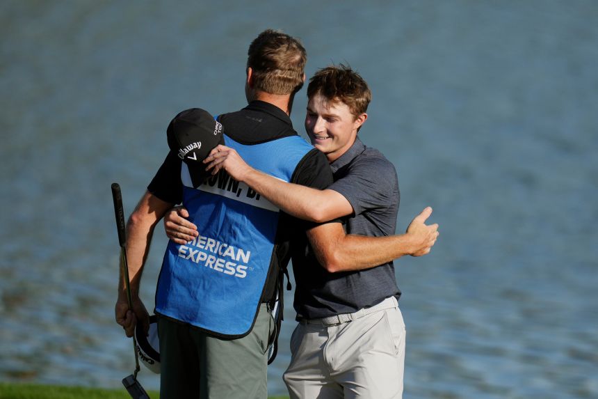 Blades Brown hugs his caddie after shooting a 12-under 60 during the second round of The American Express in La Quinta, California, on Friday.