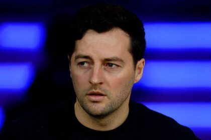 Ryan Mason sits in the dugout during a match