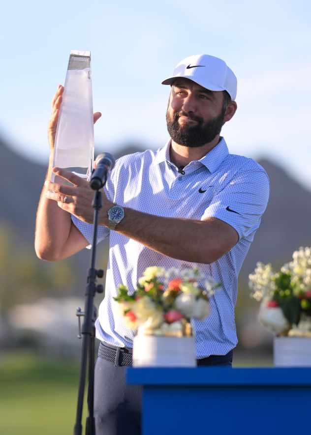 Scottie Scheffler of the United States lifts the American Express Trophy after winning the final round of The American Express 2026 at Pete Dye Stadium Course on Sunday in La Quinta, California.