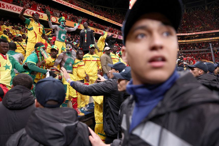 Security personnel block angry fans over a penalty decision against Senegal.