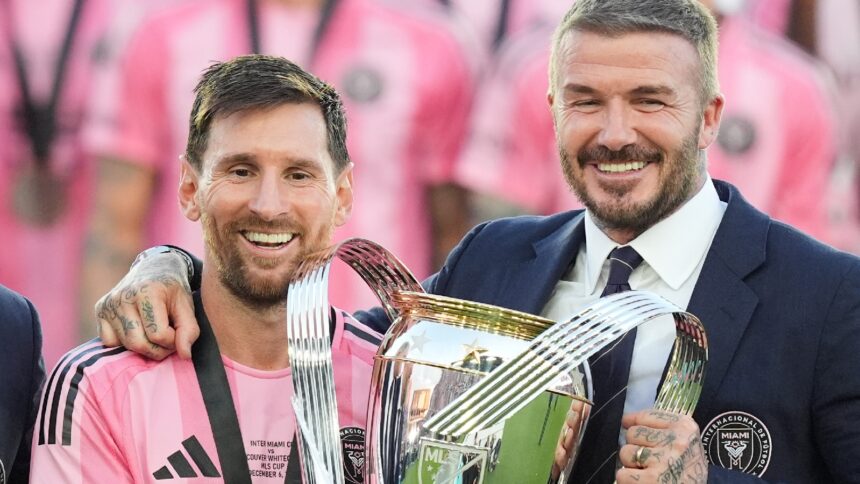 David Beckham poses with the MLS Cup trophy with Inter Miami forward Lionel Messi Saturday, Dec. 6, 2025, in Fort Lauderdale, Fla. (AP Photo)