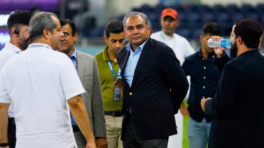 Pakistan's Minister of Interior and President of the Asian Cricket Council Mohsin Naqvi, center, stands with officials on the field after India won the Asia Cup cricket final against Pakistan at Dubai International Cricket Stadium, United Arab Emirates, Sunday, Sept. 28, 2025. (AP Photo)