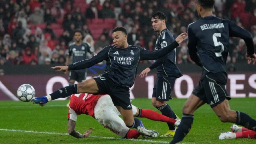 Real Madrid's Kylian Mbappe attempts a shoot at goal during a Champions League opening phase soccer match between Benfica and Real Madrid, in Lisbon. (AP Photo)
