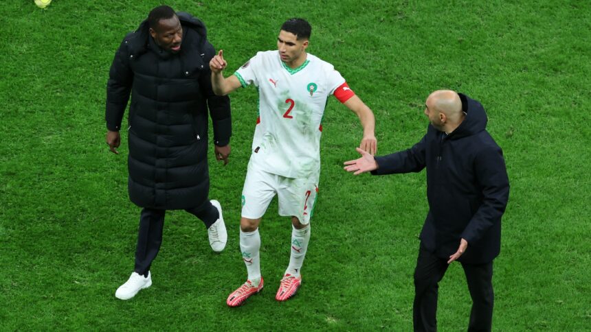 Senegal's head coach Pape Thiaw, left, Morocco's head coach Walid Regragui, right, and Morocco's Achraf Hakimi argue after a controversial penalty was awarded in the AFCON final. (AP Photo)