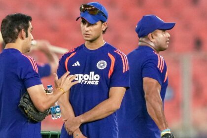 India's Abhishek Sharma, centre, and head coach Gautam Gambhir, left, interact during a practice session before an ICC Men's T20 World Cup 2026 cricket match between India and South Africa, at the Narendra Modi Stadium, in Ahmedabad, Friday, Feb. 20, 2026. (PTI Photo)