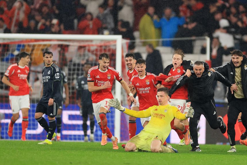 Benfica goalkeeper Anatoliy Trubin celebrates after scoring a goal in stoppage time against Real Madrid on January 28 in UEFA Champions League play.