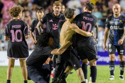 A fan who got onto the field grabs Inter Miami's Lionel Messi at the end of an international friendly soccer match against Ecuador's Independiente del Valle in Bayamon, Puerto Rico, Thursday, Feb. 26, 2026. (AP Photo)