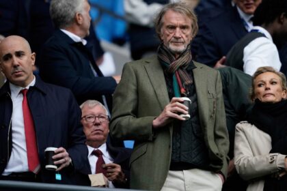 Manchester United co-owner Jim Ratcliffe stands in front of former manager Alex Ferguson during a Premier League football match in September 2025. (AP Photo)