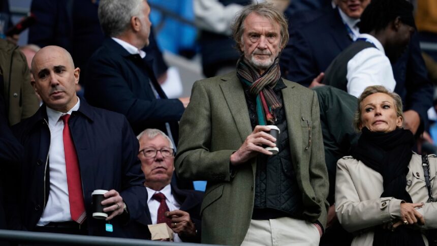 Manchester United co-owner Jim Ratcliffe stands in front of former manager Alex Ferguson during a Premier League football match in September 2025. (AP Photo)