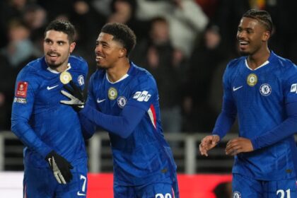 Chelsea's Pedro Neto, left, Wesley Fofana, center, and Jorrel Hato react after a goal during the English FA Cup fourth round soccer match between Hull City and Chelsea in Hull, England, Friday, Feb. 13, 2026. (AP Photo)