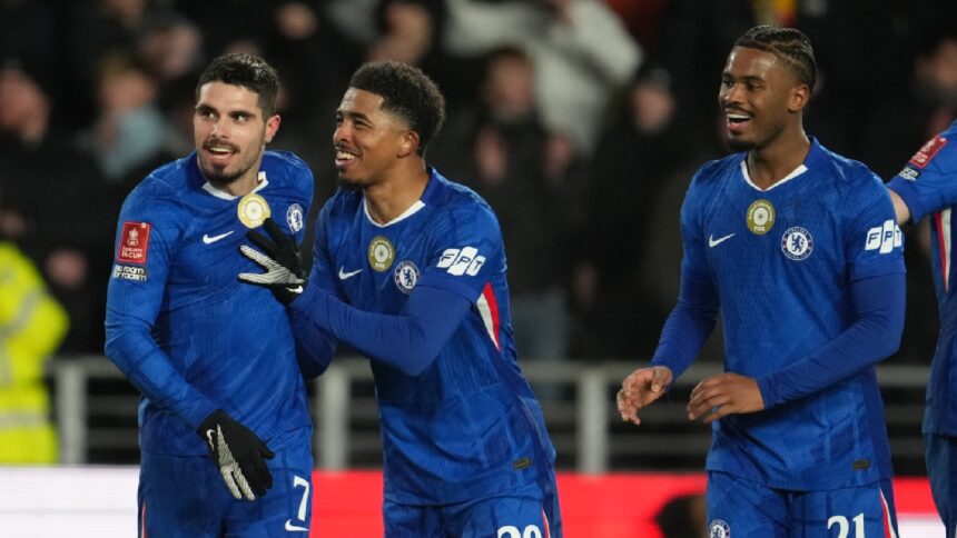 Chelsea's Pedro Neto, left, Wesley Fofana, center, and Jorrel Hato react after a goal during the English FA Cup fourth round soccer match between Hull City and Chelsea in Hull, England, Friday, Feb. 13, 2026. (AP Photo)