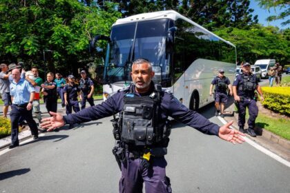 Police officers clear the road for a departing bus transporting members of the Iranian Women's Asia Cup football team to the airport outside the Royal Pines Resort on the Gold Coast on Tuesday, March 10.