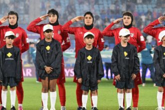 Iran players react during their national anthem ahead of the Women's Asian Cup soccer match between Iran and the Philippines in Robina, Australia, Sunday, March 8, 2026. (Dave Hunt/AAP Image via AP)