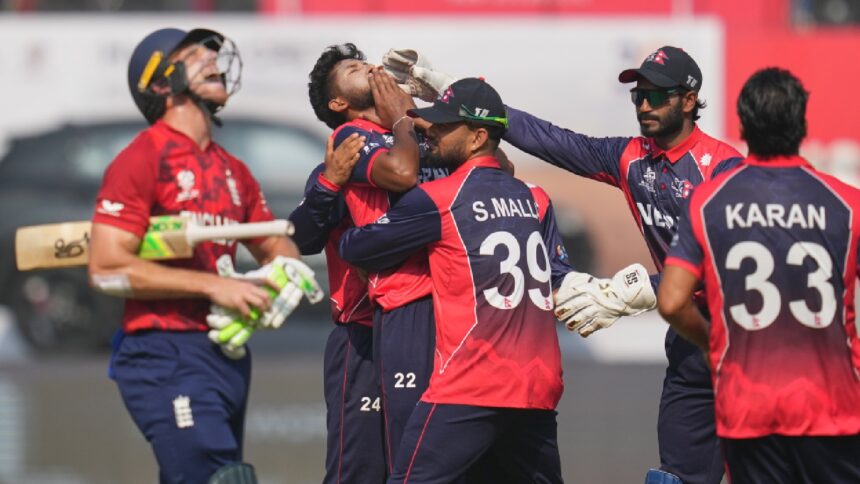 Nepal's Nandan Yadav, second left, celebrates the wicket of England's Jos Buttler, left, with teammates during the T20 World Cup cricket match between England and Nepal in Mumbai, India, Sunday,Feb. 8, 2026.(AP Photo/Rafiq Maqbool)