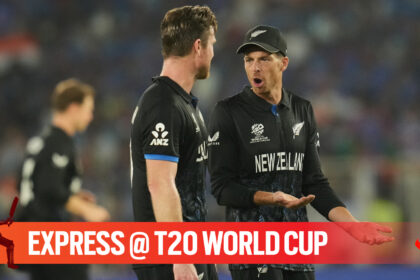 New Zealand's captain Mitchel Santner speaks to bowler James Neesham during the T20 World Cup cricket final match between India and New Zealand in Ahmedabad, India, Sunday, March 8, 2026. (AP Photo)