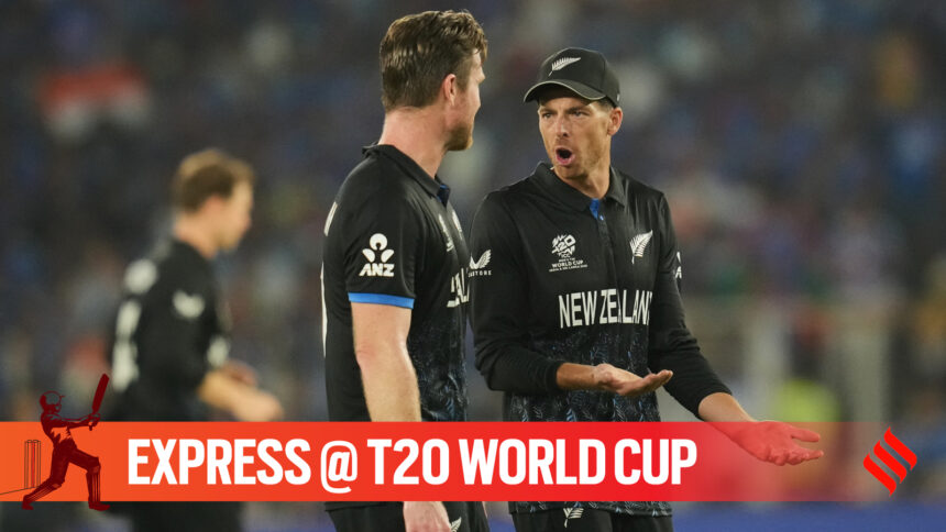 New Zealand's captain Mitchel Santner speaks to bowler James Neesham during the T20 World Cup cricket final match between India and New Zealand in Ahmedabad, India, Sunday, March 8, 2026. (AP Photo)
