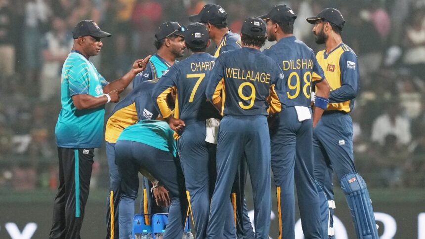 Sri Lanka's coach Sanath Jayasuriya, left, speaks to the players during a drinks break of the T20 World Cup cricket match between Pakistan and Sri Lanka in Pallekele, Sri Lanka, Saturday, Feb. 28, 2026. (AP Photo)