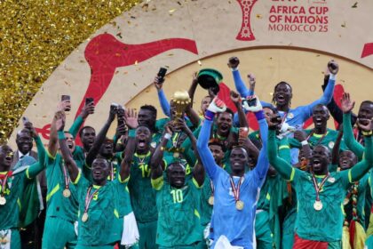 Senegal's Sadio Mane lifts the trophy with teammates as they celebrate after winning the Africa Cup of Nations. (PHOTO: Reuters)