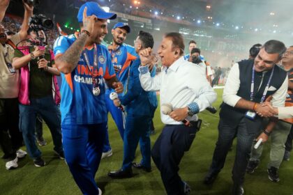 India's captain Suryakumar Yadav dances with former India international Sunil Gavaskar after India won the T20 World Cup final match against New Zealand in Ahmedabad. (PHOTO: AP)