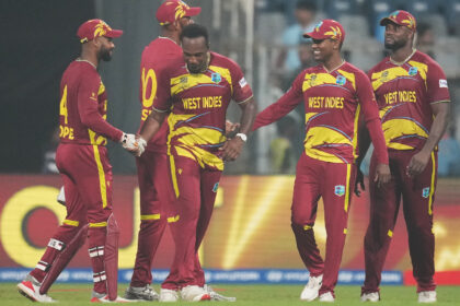 West Indies players celebrate after their win against Zimbabwe during the T20 World Cup cricket match in Mumbai. (AP Photo)