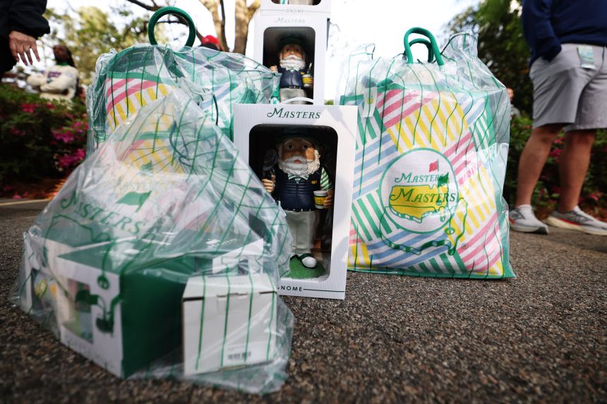 People collect Masters garden gnome souvenirs during a practice round in the Masters golf tournament in Augusta, Georgia, on April 6.