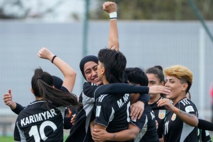 Members of the Afghan Women United football team celebrate after scoring a goal against Chad, in their first international tournament since fleeing their country in October 2025. (AP Photo)