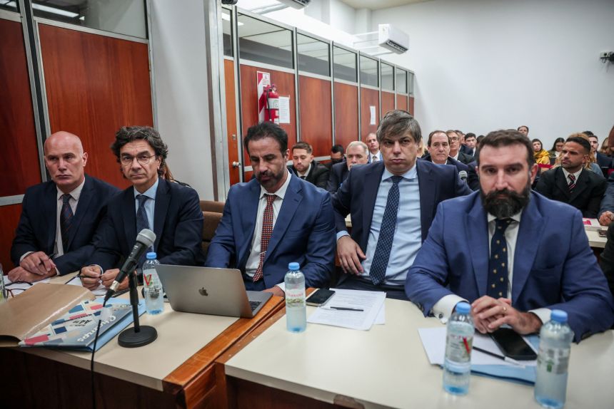 Vadim Mischanchuk, lawyer of Agustina Cosachov, psychiatrist of late Argentine soccer legend Diego Maradona, Francisco Oneto, lawyer of Maradona's personal doctor Leopoldo Luque, sit among other lawyers inside a court, in Buenos Aires, Argentina, on Tuesday.