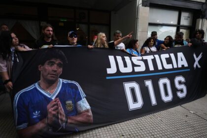 Fans of the late soccer star Diego Maradona stand outside court on the first day of the trial of his medical team for alleged homicide by negligence in San Isidro, Argentina, on Tuesday.