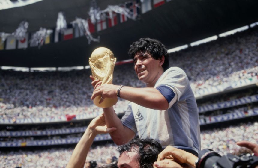 Argentine football player Diego Armando Maradona holds the World Cup trophy after Argentina defeated West Germany 3-2 during the 1986 FIFA World Cup Final in Mexico City, in 1986.