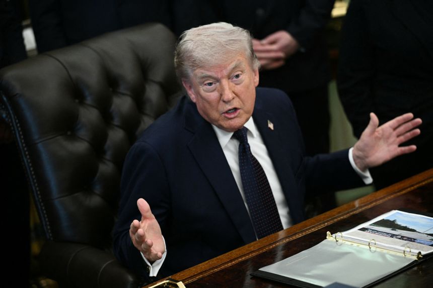 President Donald Trump speaks in the Oval Office of the White House in Washington, DC, on April 23.