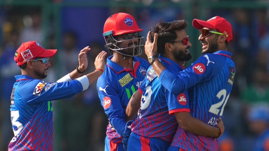Delhi Capitals' Vipraj Nigam, second left, celebrates the wicket of Mumbai Indians' Shefane Rutherford with captain Axar Patel. (Photo: AP)