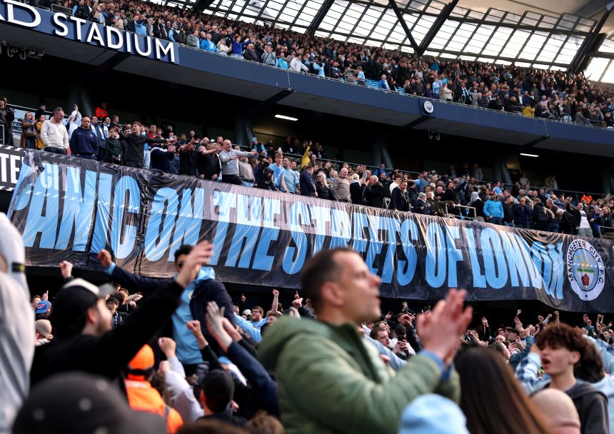 Manchester City fans display a banner which reads 'Panic on the streets of London' after their team's victory against Arsenal.