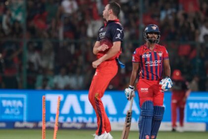 Lucknow Super Giants' Nicholas Pooran, right, reacts after getting bowled out by Royal Challengers Bengaluru's Josh Hazlewood during an Indian Premier League cricket match. (AP Photo)
