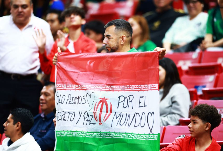 A fan holds up the flag of Iran in the stands before an Inter-Confederation semifinal match in Guadalajara, Mexico, on March 26.
