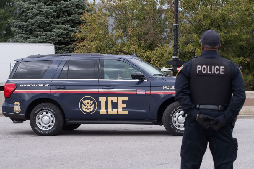 An ICE vehicle and police officer are seen near an ICE facility in Broadview, Illinois, in October.