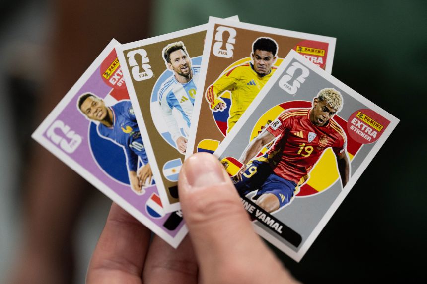A person shows newly printed, collectible World Cup cards at the Panini Group factory in Modena, Italy, on April 28.
